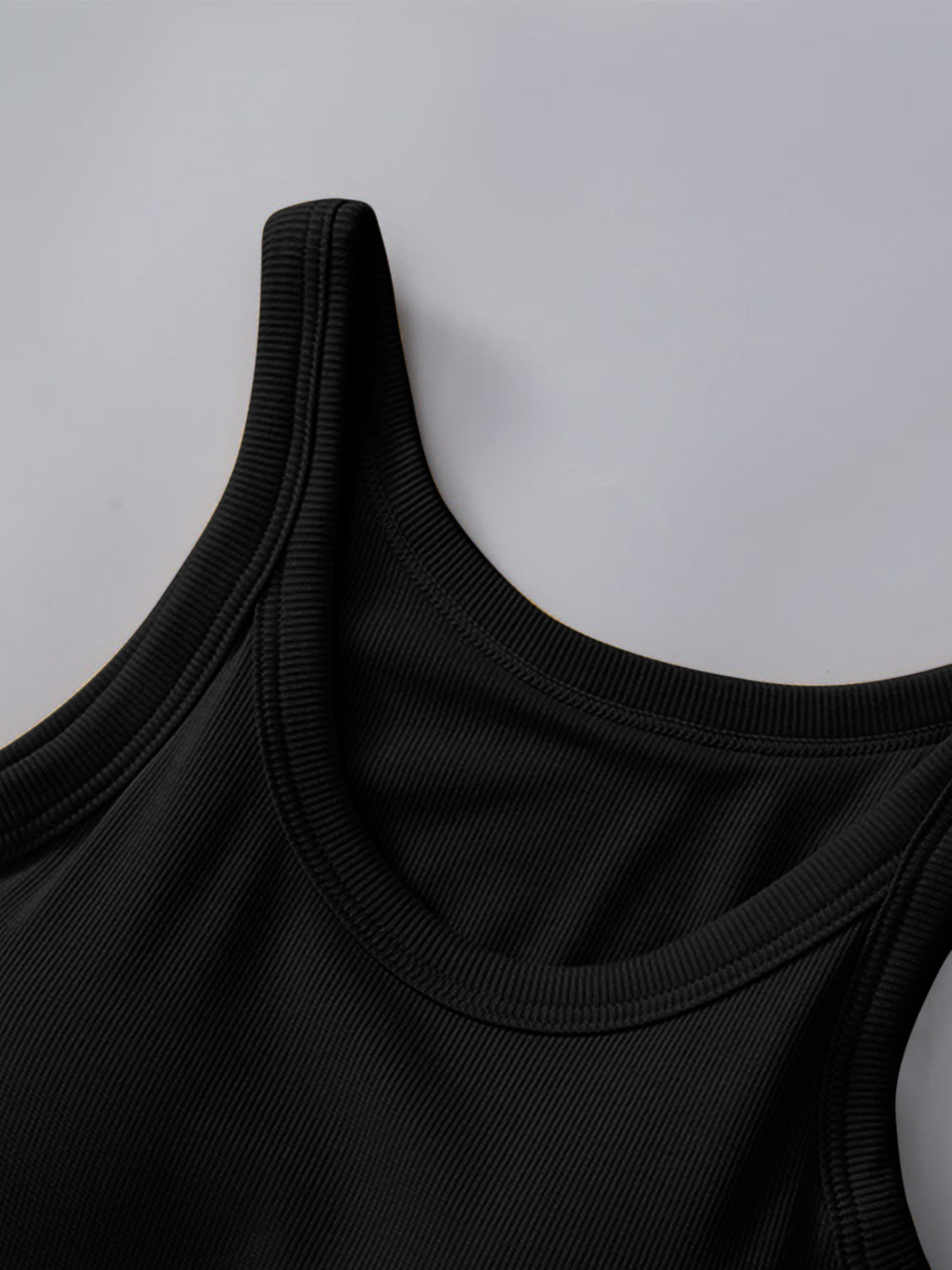 Black ribbed knit tank top with built-in bra and scoop neckline.