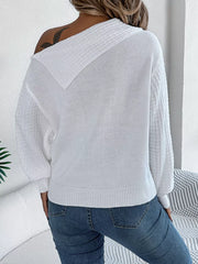 White acrylic cable knit sweater with off-shoulder neckline and textured collar detail.