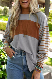 Maternity shirt with crew neck, bishop sleeves, and colorblock gray and mustard design with striped sleeves.