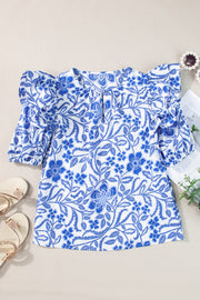 Blue floral print blouse with ruffled sleeves and a gathered neckline.
