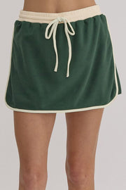 Dark green skort with cream trim and drawstring waist, part of a set.