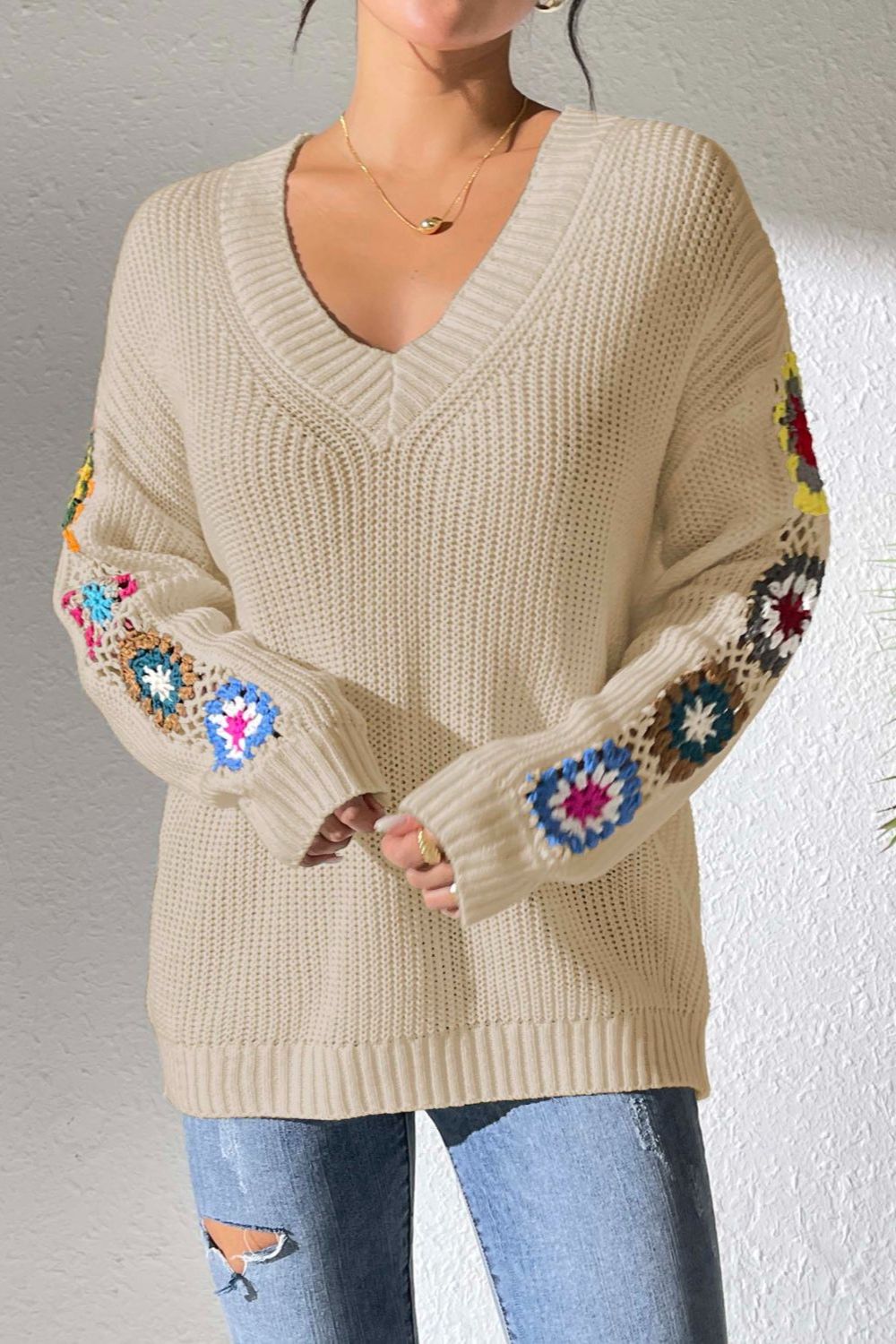 Tan knit sweater with colorful crochet granny square sleeves and V-neck.