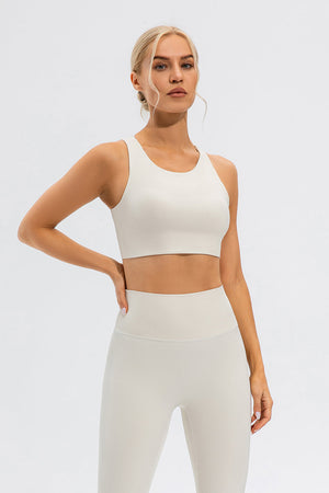 Camel sports bra with asymmetric cutout detail and racerback.