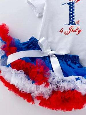 Baby outfit with white top saying 1st 4 July and red, white, blue ruffled tutu skirt.