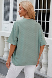 Light green open-front crochet kimono sleeve top with a circular pattern.