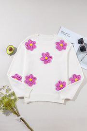 White knit sweater with 3D pink flower appliques and yellow centers.