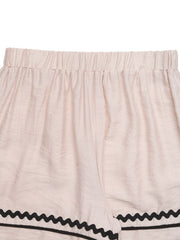 Beige elastic waist shorts with wavy black trim detail