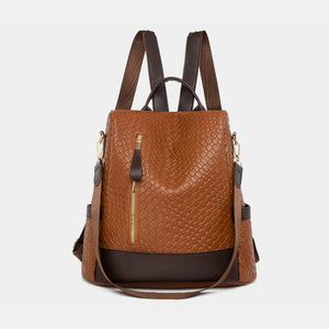 Brown woven faux leather convertible backpack with front zipper detail.