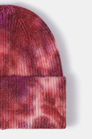Ribbed knit beanie with a pink and purple dip-dye pattern.