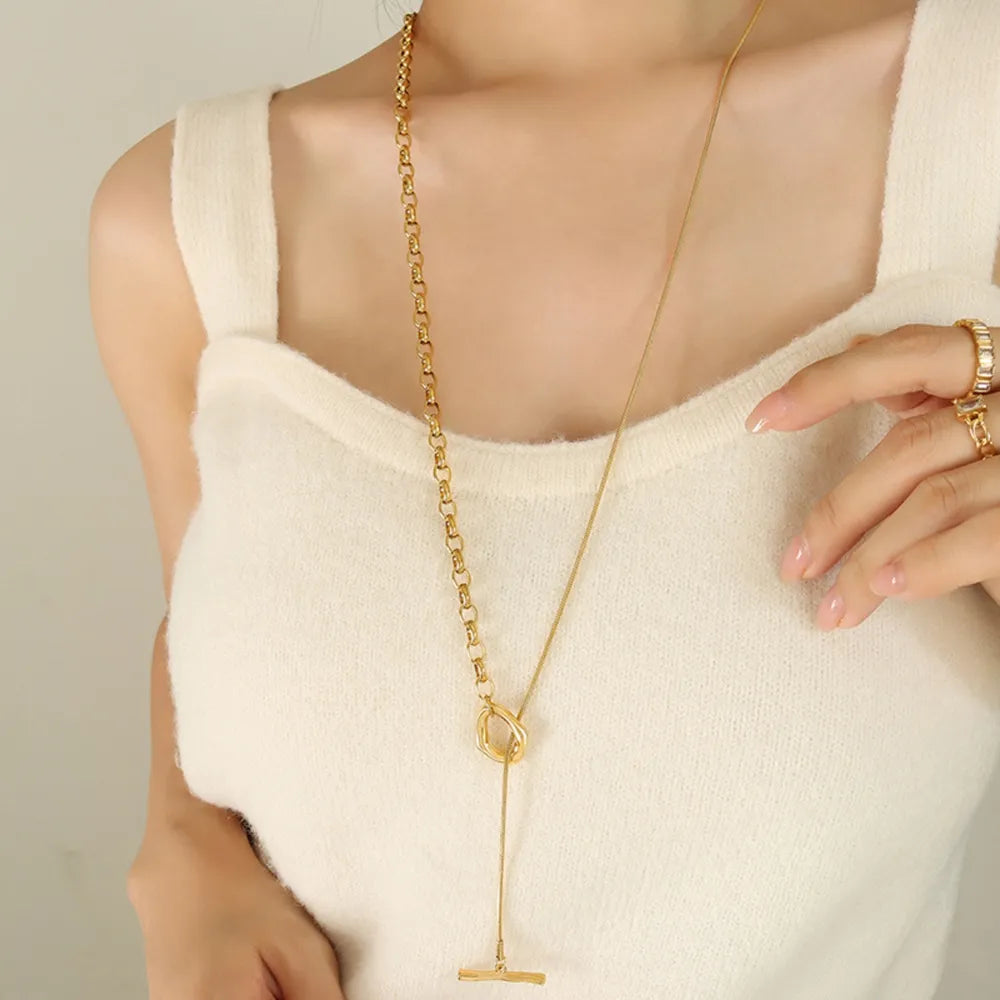 Gold asymmetrical chain and bar necklace with toggle closure detail