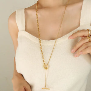 Gold asymmetrical chain and bar necklace with toggle closure detail