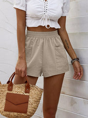 Beige elastic waist shorts with pockets, casual loungewear for women.