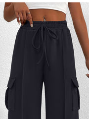 Navy high waist cargo sweatpants with drawstring and side pockets.