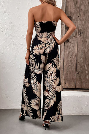 Black bandeau jumpsuit with tropical leaf print and wide legs.