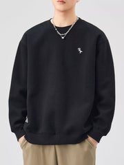 Black long-sleeve sweatshirt with crew neck and small embroidered dinosaur detail.