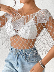 White crochet cardigan with silver beads, V-neck, short sleeves, and fringe detail.