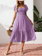 Purple floral smocked ruffle sleeve midi dress with tiered skirt.