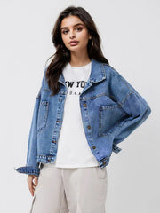 Medium wash denim trucker jacket with button front and chest pockets.