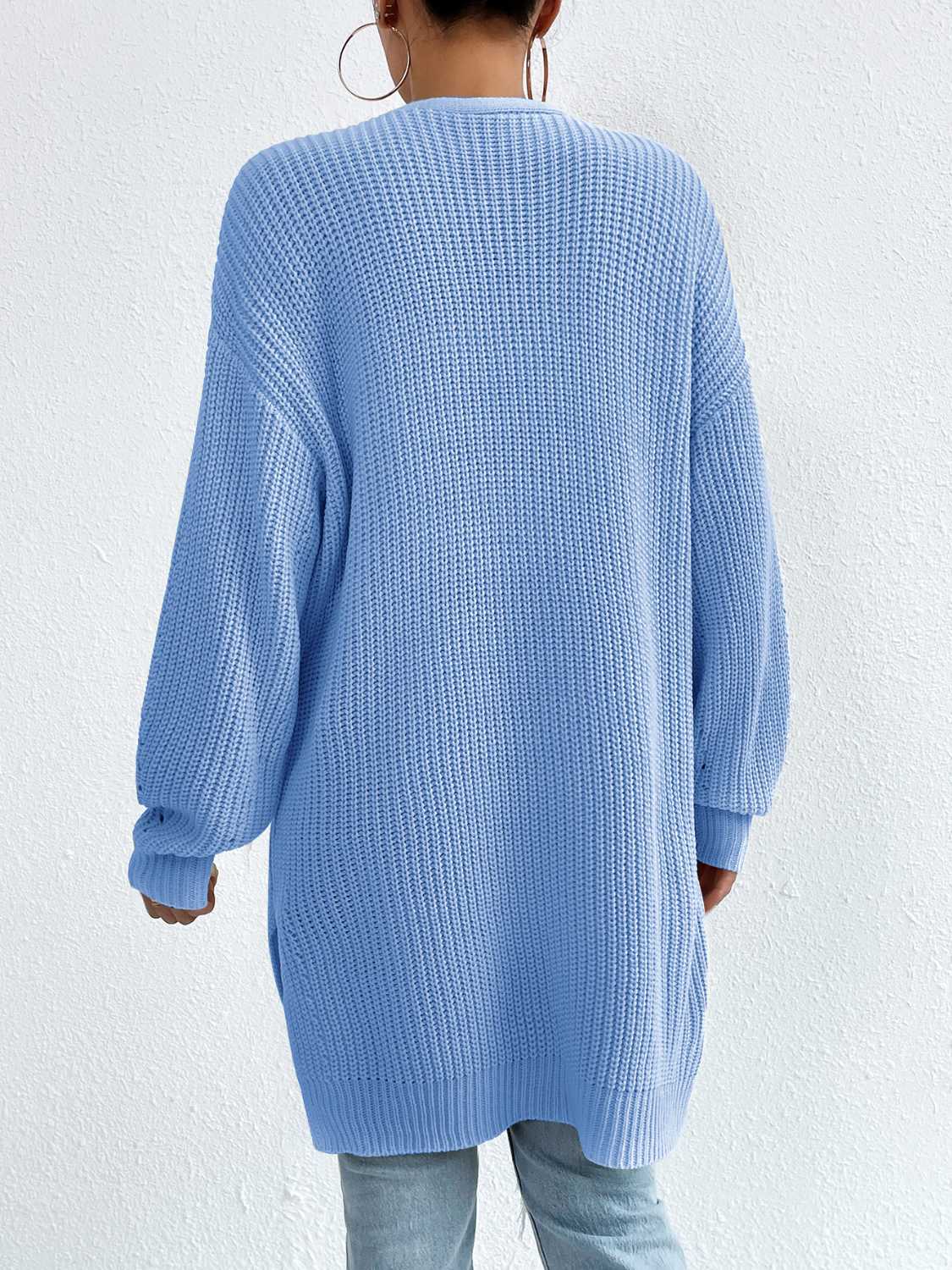 Longline knit open cardigan in Misty Blue acrylic with ribbed texture and long sleeves.