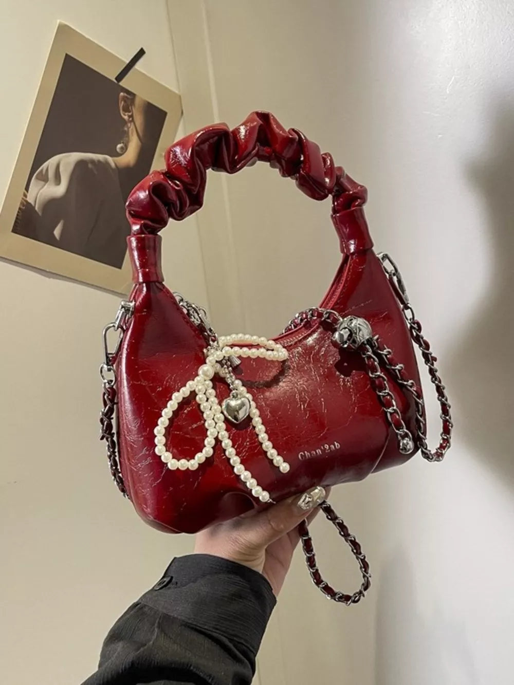 Burgundy ruched mini crossbody bag with pearl and heart pendant detail