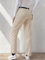 Beige wide-leg dress pants with pockets and belt loops, styled with a white top and black belt.