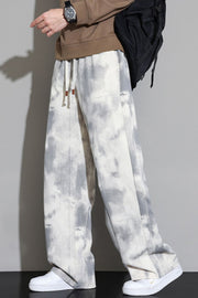 Relaxed fit sweatpants in off-white with a grey cloud pattern and drawstring waist.