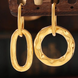 Textured gold vermeil hoop earrings with oval and wavy circular shapes.