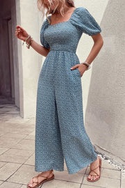 Cerulean floral print square neck jumpsuit with balloon sleeves and pockets.