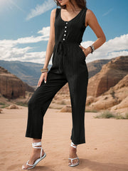 Black linen blend button-down jumpsuit with drawstring waist and wide legs.
