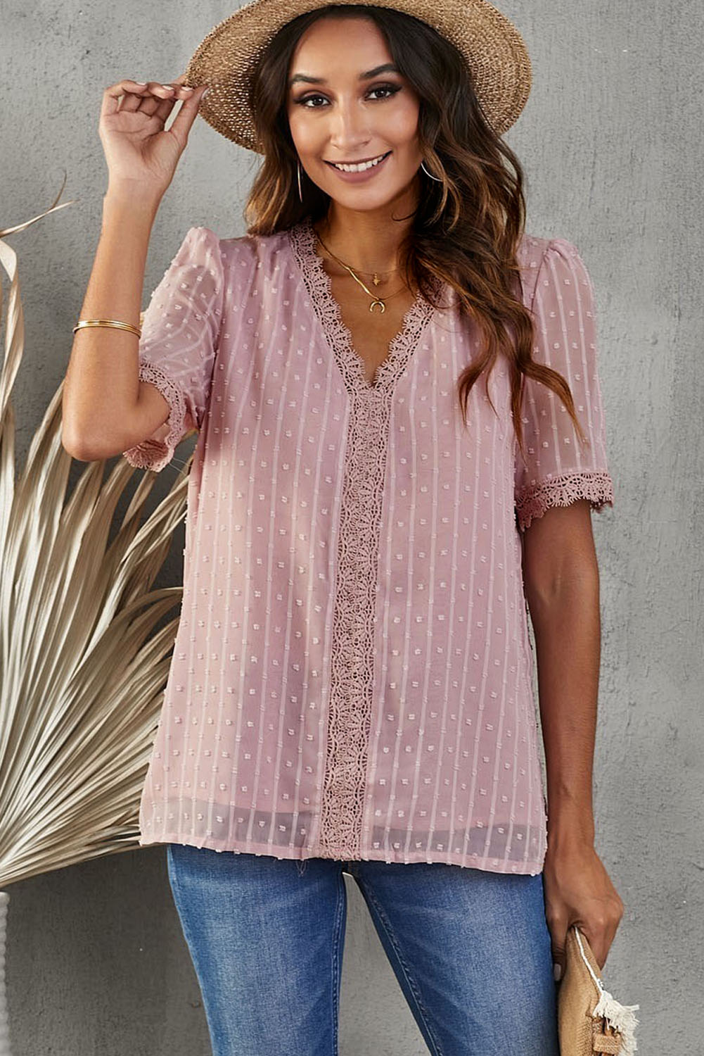 Dusty pink dotted swiss blouse with lace trim and short sleeves.