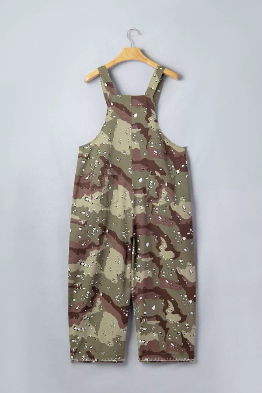 Cropped denim overalls with camouflage pattern and white speckle accents.