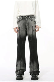 Faded flare jeans in dark wash denim with front pleat detail and distressed accents.