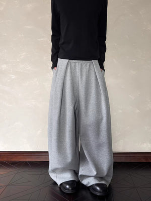 Men's grey relaxed fit sweatpants with elastic waist and pockets.