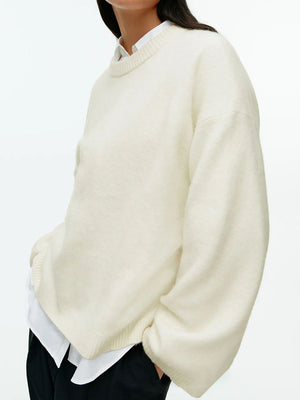 Oversized ivory brushed knit crewneck sweater with relaxed fit and crew neckline.