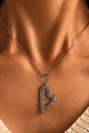 Silver woven heart pendant necklace with beaded chain detail