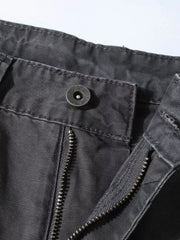 Distressed charcoal wide-leg sweatpants with paint splatter detail, showing button and zipper closure.