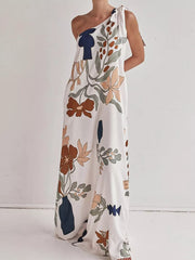 Elegant one-shoulder maxi dress with a bold floral print and tie detail.