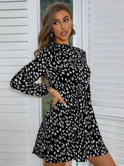 Black dotted print mini dress with gathered waist and balloon sleeves
