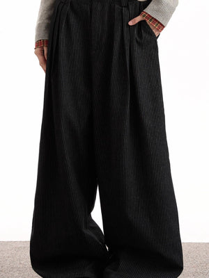 Men's black pinstripe wide-leg sweatpants with pleats and pockets.
