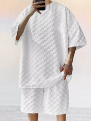 White textured casual two-piece set for men with short sleeves and shorts.
