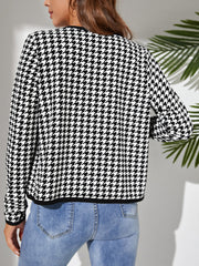 Black houndstooth jacket with trimmed edge-to-edge neckline and cuffs.
