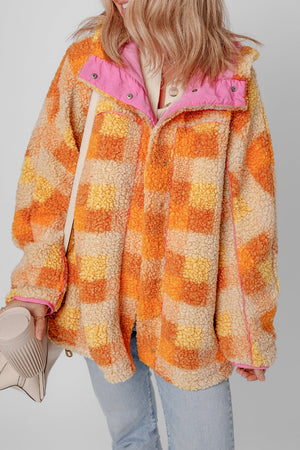 Checkerboard sherpa jacket in tangerine with contrast pink collar and trim.
