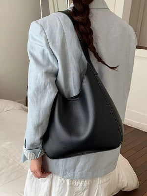 Sleek black large PU leather shoulder bag with a slouchy silhouette.