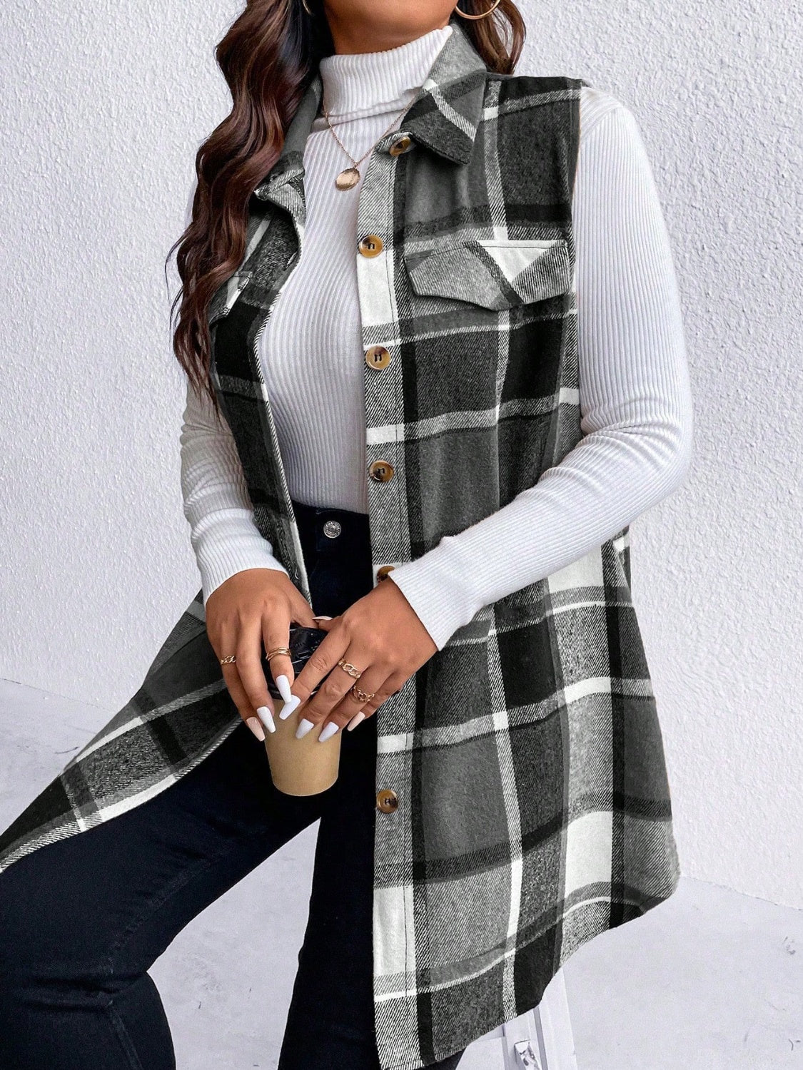 Oversized plaid shirt vest in black and white with button front and chest pockets.