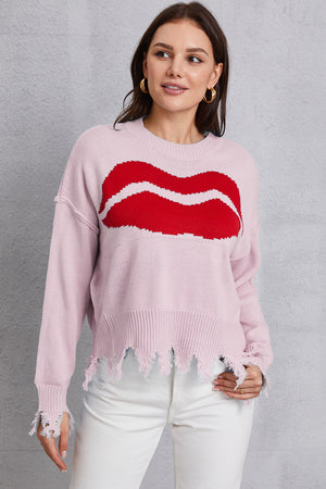 Pink knit sweater with red kiss graphic and distressed hem