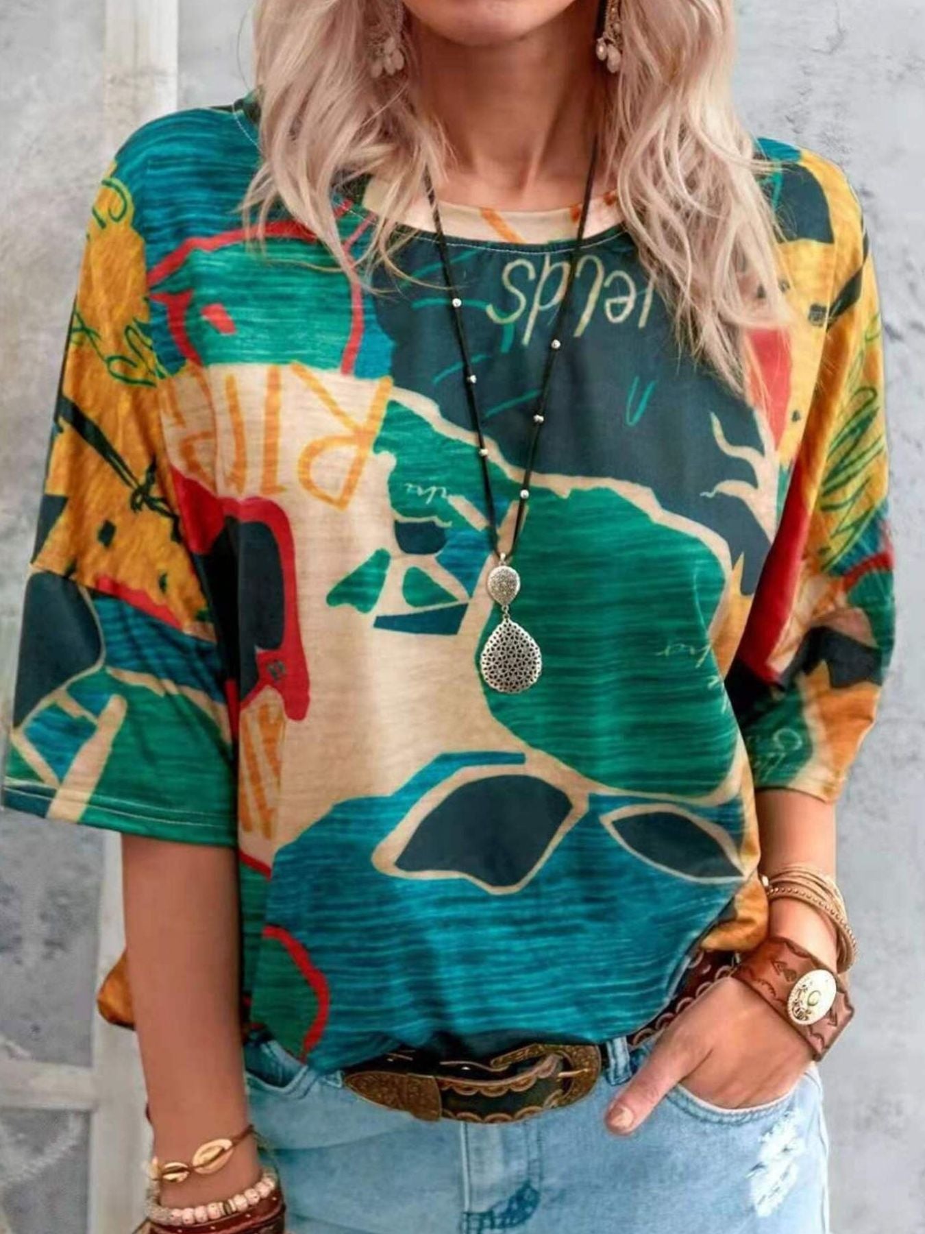 Casual t-shirt with brushstroke stripe pattern in yellow, green, blue, and orange.