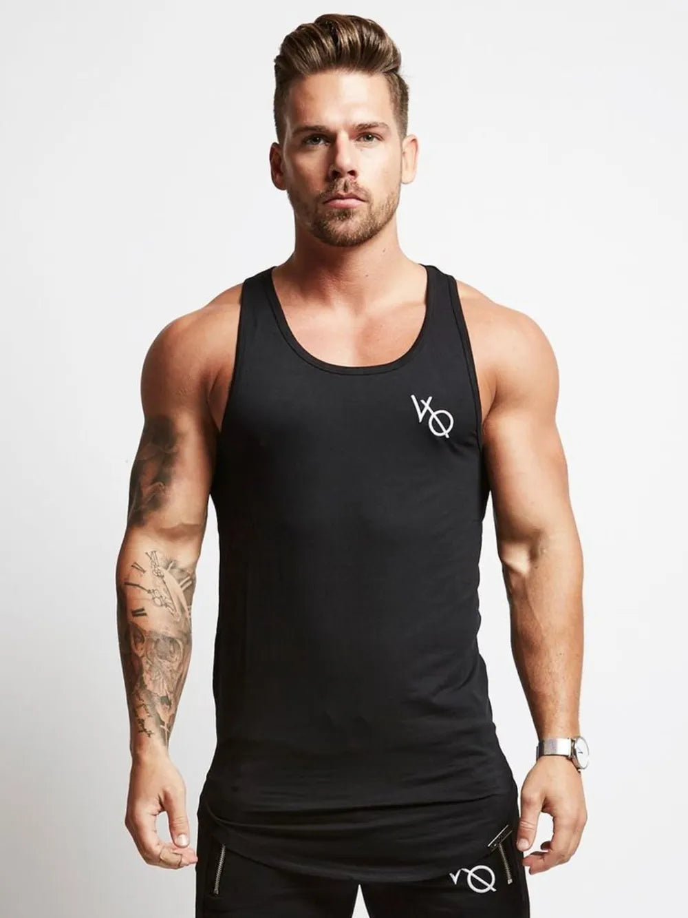 Black racerback tank top with roundneck and white logo detail.