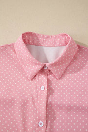Pink polka dot button-up shirt with a collared neckline.