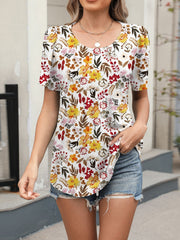 Women's white floral print short sleeve blouse with scoop neck.