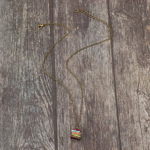 Stacked prism charm necklace with multicolor stacked charm and antique brass chain.
